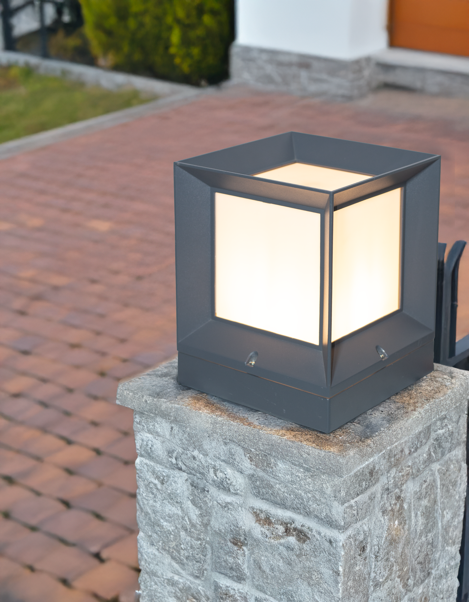 Modern Cube Gate Light by Kyess Lighting, mounted on a stone pillar, providing soft, ambient lighting in a residential driveway