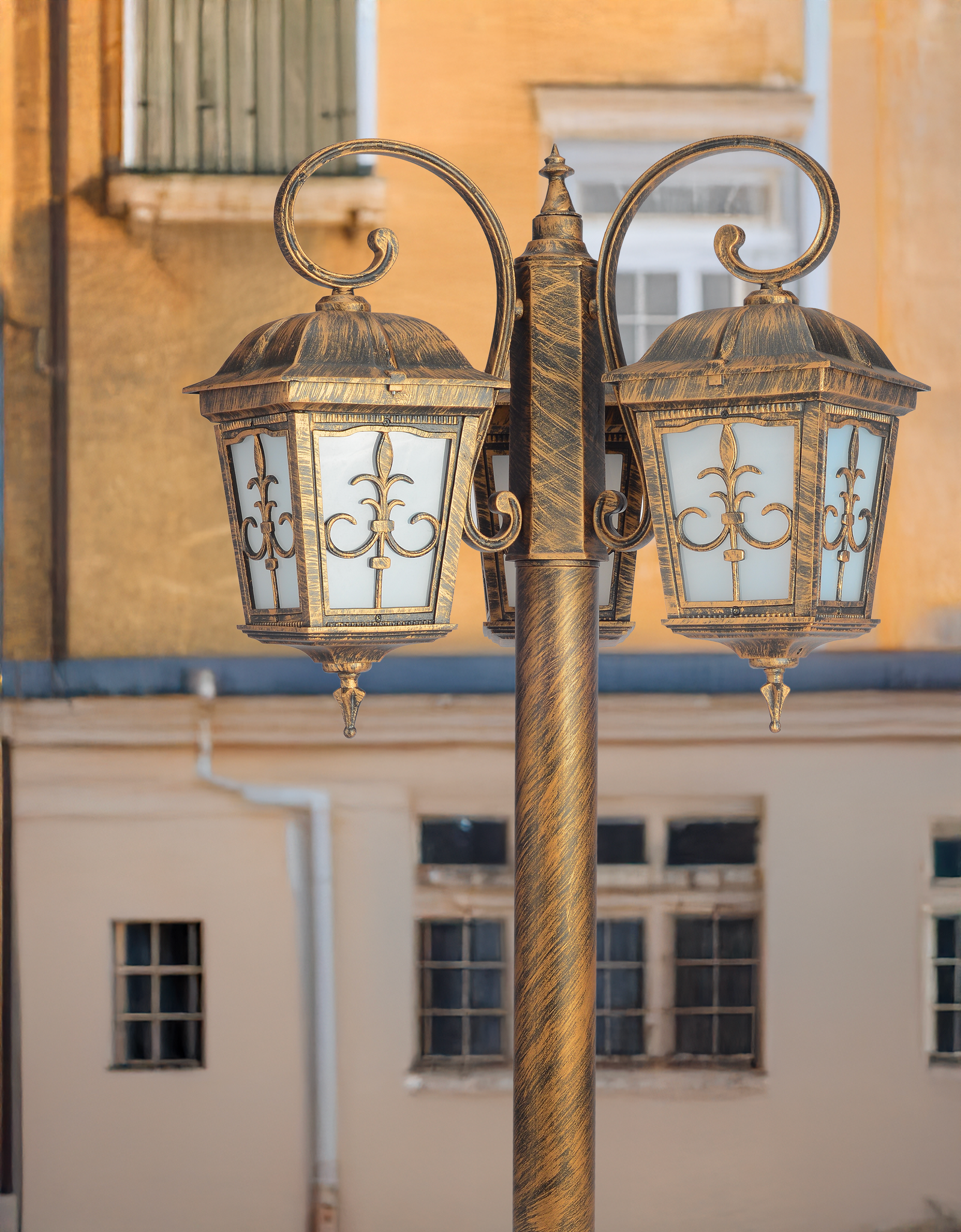 Elegant Cascade P27 Pole Light with three lamps, showcased against a historical building backdrop, blending traditional aesthetics with modern lighting technology